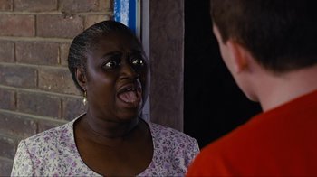 An older woman is making an angry face at a young man