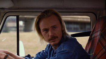 A man sitting in the passenger seat of a car