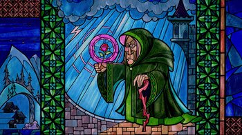 Movie still from “Beauty and the Beast” (1991), directed by Kirk Wise – An old man in a green robe is holding a wand; Medium shot, Low angle