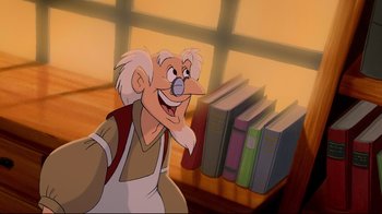 Movie still from “Beauty and the Beast” (1991), directed by Kirk Wise – An old man is smiling in front of some books; Medium shot, Low angle