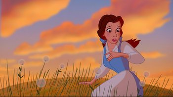 Movie still from “Beauty and the Beast” (1991), directed by Kirk Wise – A beautiful woman in a field of grass; Wide shot, Low angle