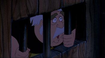 Movie still from “Beauty and the Beast” (1991), directed by Kirk Wise – An old man is looking through a jail cell window; Close Up shot, Low angle