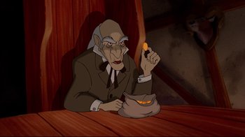 Movie still from “Beauty and the Beast” (1991), directed by Kirk Wise – An old man sitting at a table with a bowl of food in front of him; Medium shot, High angle