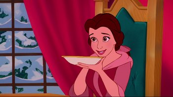 Movie still from “Beauty and the Beast” (1991), directed by Kirk Wise – A woman holding a plate in her hands; Medium shot, High angle