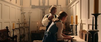 Movie still from “Beauty and the Beast” (2017), directed by Bill Condon – A man and a woman standing next to each other in front of a cross; Medium shot, Over the shoulder angle