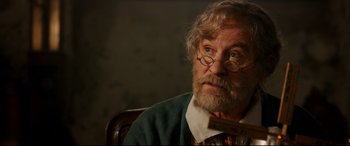 Movie still from “Beauty and the Beast” (2017), directed by Bill Condon – An older man with a beard and glasses; Close Up shot, Over the shoulder angle