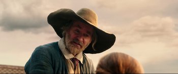Movie still from “Beauty and the Beast” (2017), directed by Bill Condon – An old man with a beard wearing a hat; Close Up shot, Over the shoulder angle