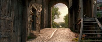 Movie still from “Beauty and the Beast” (2017), directed by Bill Condon – An archway leading to a door way with a view of a river; Extreme Wide shot, Low angle