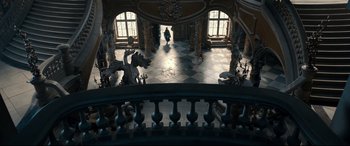 Movie still from “Beauty and the Beast” (2017), directed by Bill Condon – A person walking down a hall way in a building; Extreme Wide shot, High angle