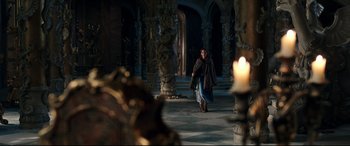 Movie still from “Beauty and the Beast” (2017), directed by Bill Condon – A woman walking down the hall of a castle; Wide shot, Over the shoulder angle