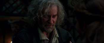 Movie still from “Beauty and the Beast” (2017), directed by Bill Condon – An old man with a beard and long curly hair; Close Up shot, Over the shoulder angle