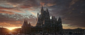 Movie still from “Beauty and the Beast” (2017), directed by Bill Condon – A castle with a sky filled with dark clouds; Extreme Wide shot, Low angle