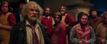 Movie still from “Beauty and the Beast” (2017), directed by Bill Condon – A group of men standing next to each other; Medium shot, Over the shoulder angle