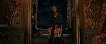 Movie still from “Beauty and the Beast” (2017), directed by Bill Condon – A woman standing in front of a window; Medium shot, Low angle