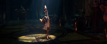 Movie still from “Beauty and the Beast” (2017), directed by Bill Condon – A figurine of a man with a candle in his hand; Wide shot, Low angle