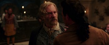 Movie still from “Beauty and the Beast” (2017), directed by Bill Condon – A man with long hair and a beard talking to another man with long hair and a beard; Close Up shot, Over the shoulder angle