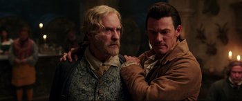 Movie still from “Beauty and the Beast” (2017), directed by Bill Condon – Two men standing next to each other in a room; Close Up shot, Over the shoulder angle