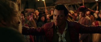 Movie still from “Beauty and the Beast” (2017), directed by Bill Condon – A man that is wearing a red leather jacket; Medium shot, Over the shoulder angle