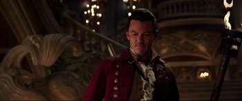 Movie still from “Beauty and the Beast” (2017), directed by Bill Condon – A person wearing a red jacket; Medium shot, Over the shoulder angle