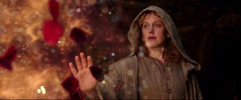 Movie still from “Beauty and the Beast” (2017), directed by Bill Condon – A woman wearing a hooded jacket and a hood is holding her hand out; Close Up shot, Low angle
