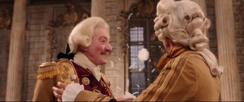 Movie still from “Beauty and the Beast” (2017), directed by Bill Condon – A man and a woman dressed in period costumes; Medium shot, Over the shoulder angle