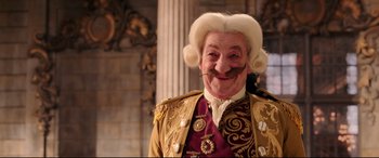 Movie still from “Beauty and the Beast” (2017), directed by Bill Condon – An old man with a mustache and a wig; Close Up shot, Low angle
