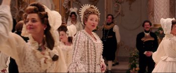 Movie still from “Beauty and the Beast” (2017), directed by Bill Condon – A group of women in period dress standing in a room; Medium shot, Over the shoulder angle