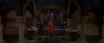 Movie still from “Becket” (1964), directed by Peter Glenville – Three people standing in front of an ornate staircase; Extreme Wide shot, High angle