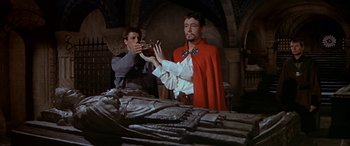 Movie still from “Becket” (1964), directed by Peter Glenville – Two men in medieval garb looking at a statue; Medium shot, Low angle