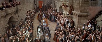 Movie still from “Becket” (1964), directed by Peter Glenville – A large crowd of people are gathered in a medieval town; Extreme Wide shot, High angle