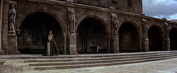 Movie still from “Becket” (1964), directed by Peter Glenville – A statue of a man standing in front of an archway; Extreme Wide shot, High angle
