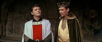 Movie still from “Becket” (1964), directed by Peter Glenville – Two men dressed in medieval clothing standing next to each other; Medium shot, Low angle