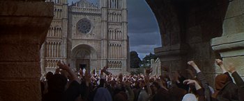 Movie still from “Becket” (1964), directed by Peter Glenville – A crowd of people standing in front of a building; Extreme Wide shot, High angle