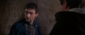 Movie still from “Becket” (1964), directed by Peter Glenville – A person wearing chains; Close Up shot, Over the shoulder angle