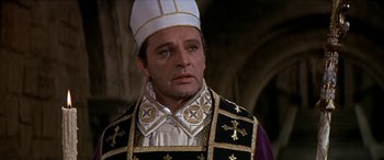Movie still from “Becket” (1964), directed by Peter Glenville – A man wearing a priest's outfit in a movie scene; Close Up shot, High angle