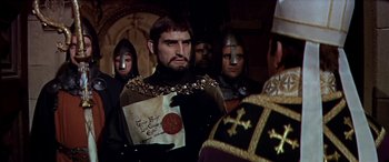 Movie still from “Becket” (1964), directed by Peter Glenville – A group of people dressed in medieval costumes; Medium shot, Over the shoulder angle