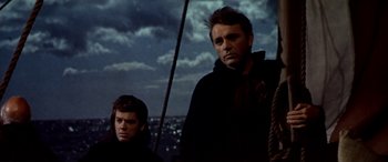Movie still from “Becket” (1964), directed by Peter Glenville – Two men standing on a boat in the dark; Medium shot, Low angle