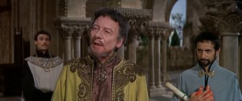 Movie still from “Becket” (1964), directed by Peter Glenville – An older man wearing a yellow and brown jacket; Medium shot, Over the shoulder angle