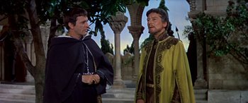 Movie still from “Becket” (1964), directed by Peter Glenville – Two men in medieval garb standing next to each other; Medium shot, Over the shoulder angle