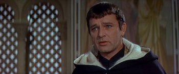 Movie still from “Becket” (1964), directed by Peter Glenville – A person wearing a suit and tie; Close Up shot, Over the shoulder angle