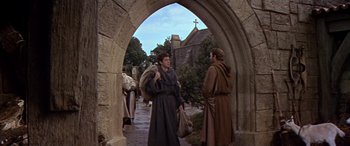 Movie still from “Becket” (1964), directed by Peter Glenville – Two men dressed as monks are walking through an archway; Wide shot, High angle