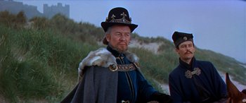 Movie still from “Becket” (1964), directed by Peter Glenville – An old man in a hat and a cape; Medium shot, Low angle