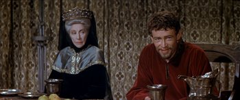 Movie still from “Becket” (1964), directed by Peter Glenville – A man and a woman sitting at a table; Medium shot, Over the shoulder angle