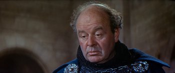 Movie still from “Becket” (1964), directed by Peter Glenville – An older man wearing a chain around his neck; Close Up shot, High angle