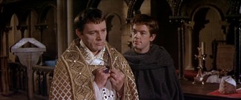 Movie still from “Becket” (1964), directed by Peter Glenville – Two men in medieval garb standing next to each other; Medium shot, Over the shoulder angle
