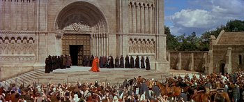 Movie still from “Becket” (1964), directed by Peter Glenville – A group of people standing in front of a building; Extreme Wide shot, High angle