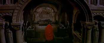 Movie still from “Becket” (1964), directed by Peter Glenville – A man in a red robe sitting in front of an altar; Extreme Wide shot, High angle