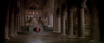 Movie still from “Becket” (1964), directed by Peter Glenville – A person in a red robe standing inside a church; Extreme Wide shot, High angle