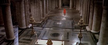 Movie still from “Becket” (1964), directed by Peter Glenville – A man in a red robe standing in a large room; Extreme Wide shot, High angle