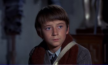 Movie still from “Bedknobs and Broomsticks” (1971), directed by Ward Kimball – A young boy wearing a scarf and a tie; Close Up shot, High angle